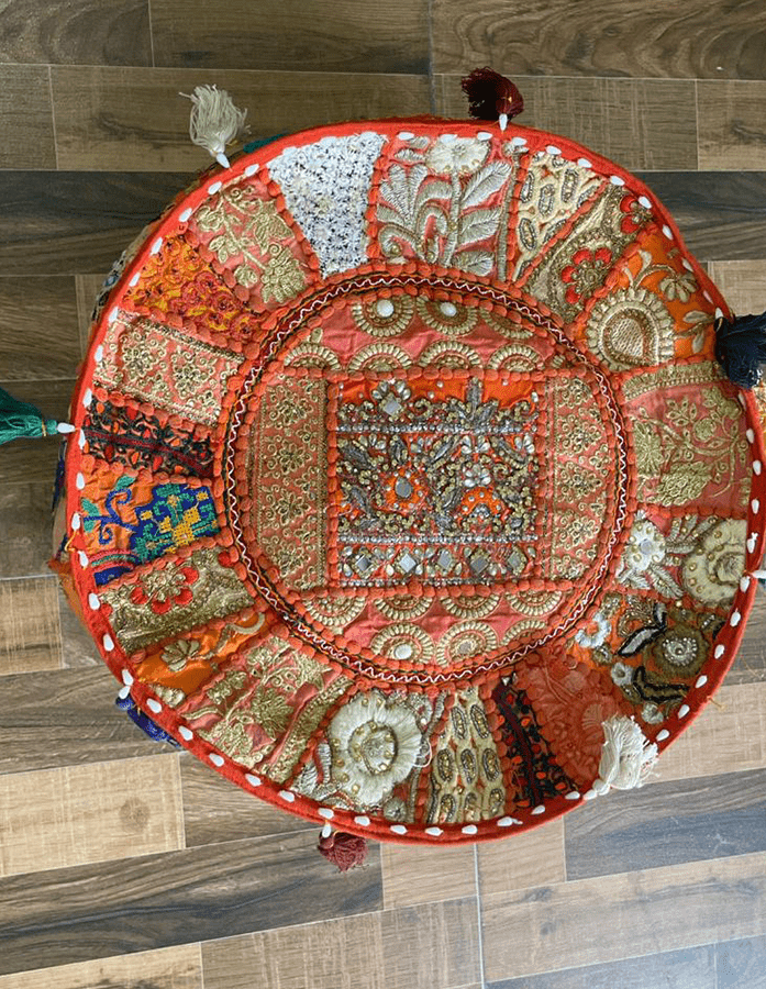 A handmade orange coloured Pouf With embroidery perfect for living room