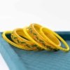 Yellow Bangles Set with Green and Red Accents