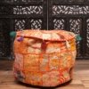 A handmade orange coloured Pouf With embroidery perfect for living room